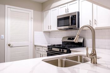 Stunning new kitchens with custom white cabinetry and gleaming granite countertops*